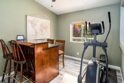 a home office with a treadmill and a desk at The Nest-2 K Beds-Game Room-Deck-5 min to Mariposa in Mariposa