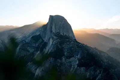 a mountain peak with the sun setting on it at Ely Farm House - Near Yosemite National Park in Oakhurst