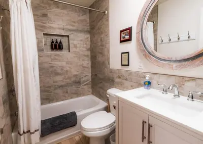 a bathroom with a sink toilet and a mirror at Ely Farm House - Near Yosemite National Park in Oakhurst