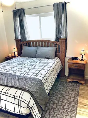 a bedroom with a bed and a window at Ely Farm House - Near Yosemite National Park in Oakhurst