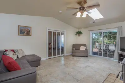 a living room with a couch and a ceiling fan at Sullivan House & SPA Near Yosemite, 8 Min to Town in Mariposa