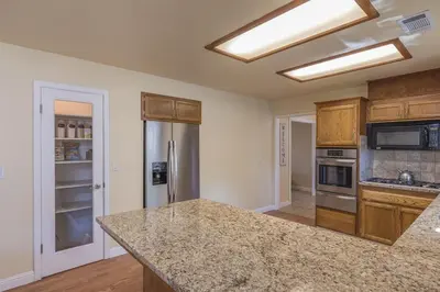 a kitchen with a counter top and a stove top oven at Sullivan House & SPA Near Yosemite, 8 Min to Town in Mariposa