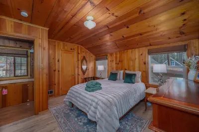 a bedroom with a bed in a wooden room at Tahoe Heavenly Hideaway 1060H in South Lake Tahoe