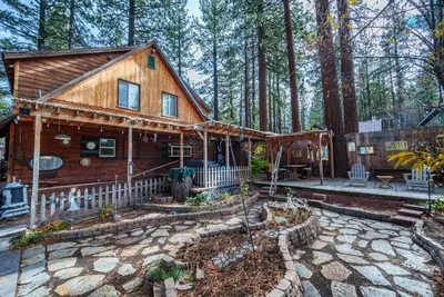 a log cabin in the woods with a patio at Tahoe Heavenly Hideaway 1060H in South Lake Tahoe