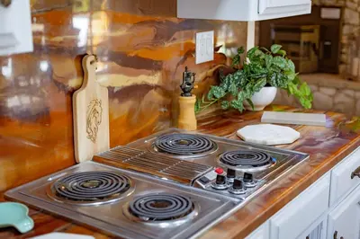 a stove top oven sitting on top of a kitchen counter at Kindred Spirits Lodge near Yosemite & Bass Lake! in Oakhurst