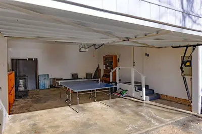 an empty garage with a ping pong table in it at Kindred Spirits Lodge near Yosemite & Bass Lake! in Oakhurst