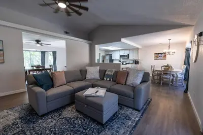 a living room with a couch and a table at Moonrise Retreat, SPA, Near Yosemite & Bass Lake in Oakhurst