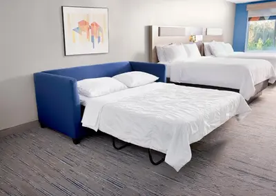a hotel room with two beds and a couch at Holiday Inn Express & Suites Sparks Reno East by IHG in Sparks