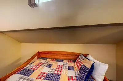 a bed with a wooden headboard and two pillows at Eagle's Nest in Big Creek