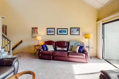 a living room with a leather couch in a room at Eagle's Nest in Big Creek