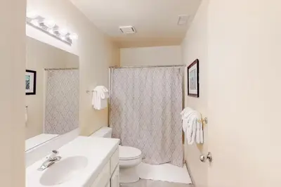 a white bathroom with a toilet and a sink at Eagle's Nest in Big Creek