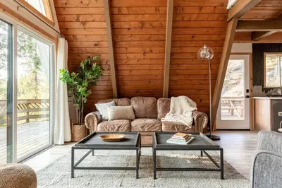 a living room with a couch and a table at Acorn Falls, Bass Lake, Ca in Bass Lake