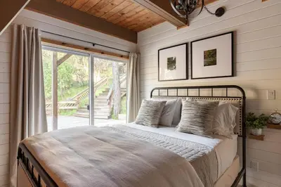 a bedroom with a bed and a sliding glass door at Acorn Falls, Bass Lake, Ca in Bass Lake