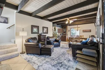 a living room with leather furniture and a wooden ceiling at Boss's Cabin - Boss-level views, zero stress! in Shaver Lake