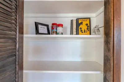 a shelf in a room with books and books at Boss's Cabin - Boss-level views, zero stress! in Shaver Lake