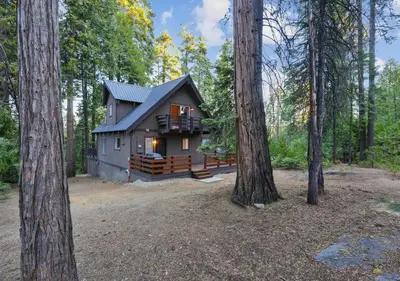 a cabin in the woods with two trees at Boss's Cabin - Boss-level views, zero stress! in Shaver Lake