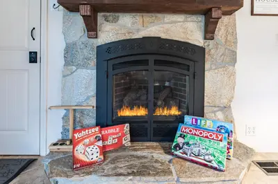a fireplace with two boxes in front of it at Boss's Cabin - Boss-level views, zero stress! in Shaver Lake
