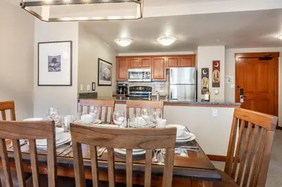 a dining room and kitchen with a table and chairs at Village 1209 in Mammoth Lakes