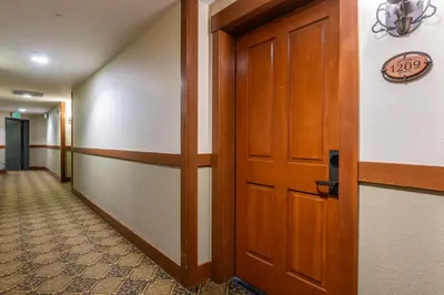 a hallway with a door and a sign on the wall at Village 1209 in Mammoth Lakes