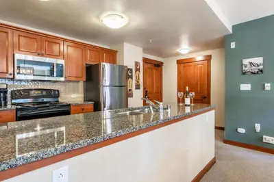 a kitchen with wooden cabinets and a counter top at Village 1209 in Mammoth Lakes