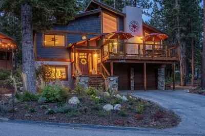 a log house with a deck and a porch at Boathouse in the Woods by Tahoe Getaways - Minutes to Lake Tahoe & Northstar in Kings Beach