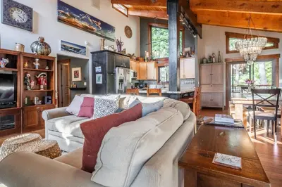 a living room with a couch and a table at Boathouse in the Woods by Tahoe Getaways - Minutes to Lake Tahoe & Northstar in Kings Beach