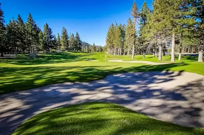 a view of a golf course with a green at Mammoth Green - 207 in Mammoth Lakes