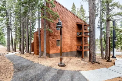 a house in the woods with a street light and trees at Northstar Resort 2BR Condo with Rec Center Access in Truckee