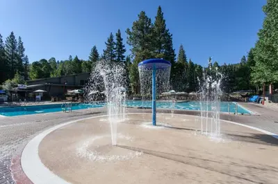a water fountain in front of a swimming pool at Northstar Resort 2BR Condo with Rec Center Access in Truckee