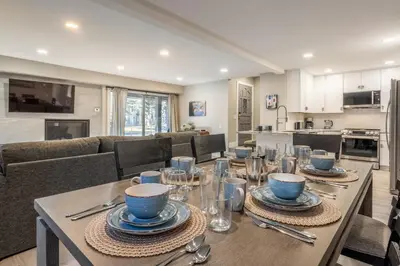 a dining room and kitchen with a table and chairs at Snowcreek IV 559 in Mammoth Lakes