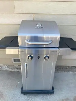 a grill sitting on a table next to a building at 3 Bedrooms - Game Room - On the water in Discovery Bay