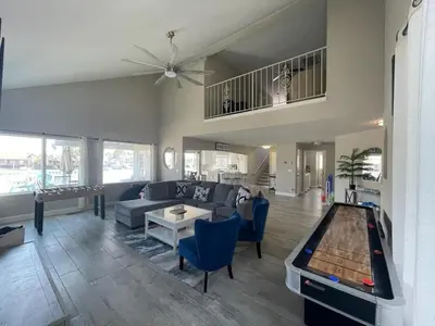 a living room with a couch and a pool table at 3 Bedrooms - Game Room - On the water in Discovery Bay