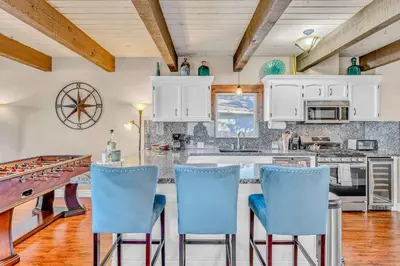 a kitchen with white cabinets and blue chairs at South Lake Retreat Deck Dock & Game Table in South Lake Tahoe
