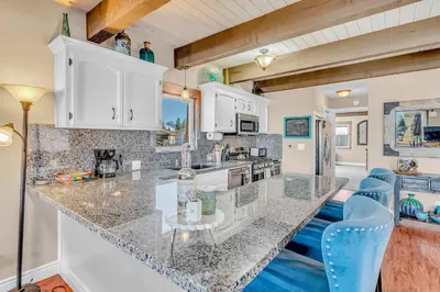 a kitchen with a counter top and blue chairs at South Lake Retreat Deck Dock & Game Table in South Lake Tahoe