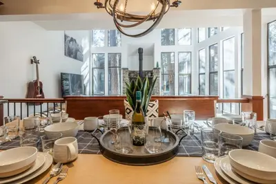 a dining room with a table with plates and glasses at St Moritz 38 in Mammoth Lakes