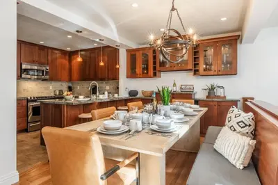 a kitchen with a wooden table and a dining room at St Moritz 38 in Mammoth Lakes