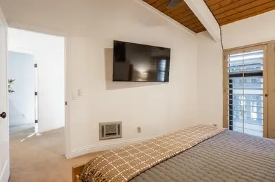 a bedroom with a bed and a tv on the wall at St Moritz 38 in Mammoth Lakes