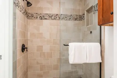 a bathroom with a shower with a white towel at St Moritz 38 in Mammoth Lakes