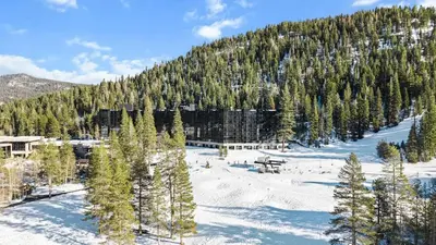 a snow covered mountain with trees and a forest at 6th Floor Fireplace Suite in Tahoe City