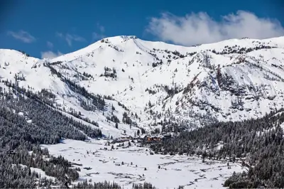 a mountain covered in snow with a town on it at 6th Floor Fireplace Suite in Tahoe City