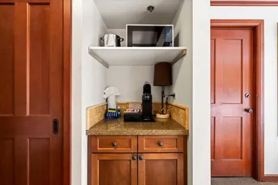 a kitchen with a counter and a red door at Studio Suite 2 Queen Beds Mountain View in Tahoe City
