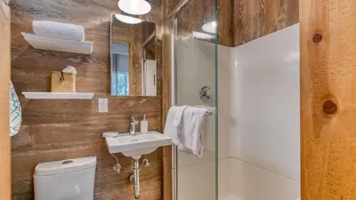 a bathroom with a toilet and a sink and a shower at Cozy Tahoe Townhome w Fireplace Balcony Quick Access to Trails Lake Cubana - Dollar Hill by AvantStay in Tahoe City