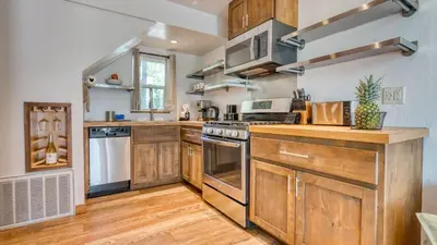 a kitchen with wooden cabinets and stainless steel appliances at Cozy Tahoe Townhome w Fireplace Balcony Quick Access to Trails Lake Cubana - Dollar Hill by AvantStay in Tahoe City