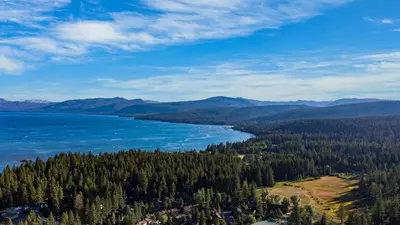a view of a lake in the middle of a forest at Cozy Tahoe Townhome w Fireplace Balcony Quick Access to Trails Lake Cubana - Dollar Hill by AvantStay in Tahoe City