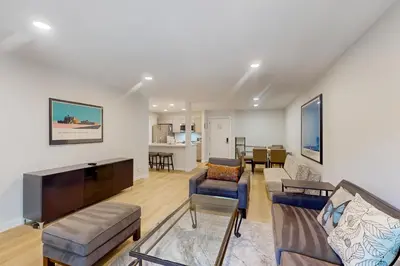 a living room with a couch and a tv at Summit 65 in Mammoth Lakes
