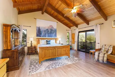 a bedroom with a bed and a living room at Yosemite Lodge 5BR Villa Hot Tub Game Room EV in Oakhurst