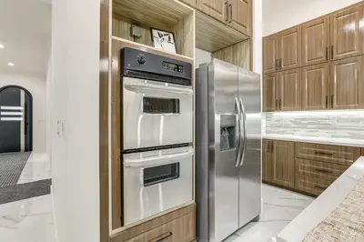 a kitchen with stainless steel appliances and wooden cabinets at Sip, Dine and Unwind Spacious Lodi Gem with Patio! in Lodi