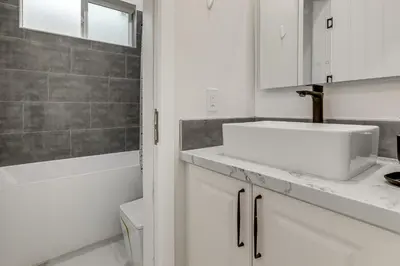 a white bathroom with a sink and a shower at Sip, Dine and Unwind Spacious Lodi Gem with Patio! in Lodi