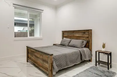 a bedroom with a wooden bed and a window at Sip, Dine and Unwind Spacious Lodi Gem with Patio! in Lodi