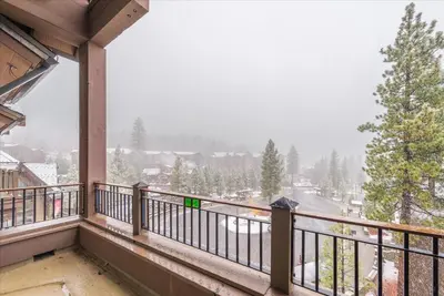 a balcony with a view of a snow covered town at Ironhorse Northstar Condo condo in Truckee